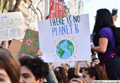 Climate protest with a group of young people with a sign reading There is no planet B